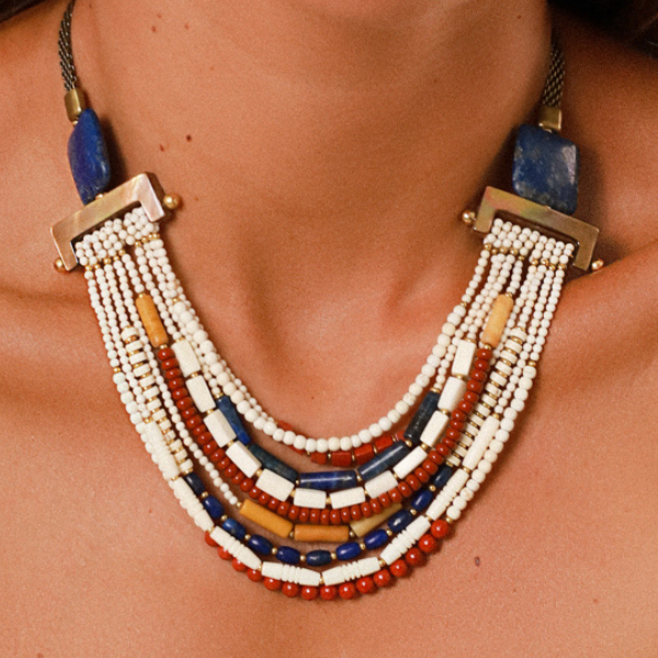 Image of model wearing ethnic style multi row necklace embellished with colourful beads.