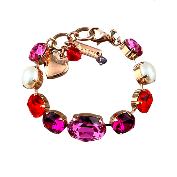 Image of chunky bracelet featuring large oval purple crystal as centrepiece embellished with red, pink swarovski crystals and faux pearl.