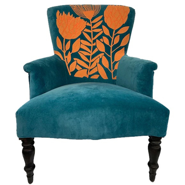 Image of of a velvet turquoise arm chair with orange waratah embroidery.