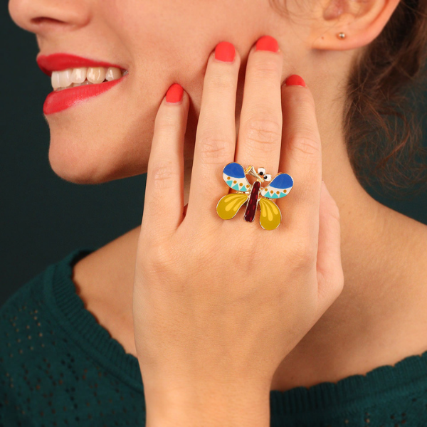 Image of Taratata ring with chartreuse, cobalt and aqua comic butterfly resin motif in gold coloured metal findings.
