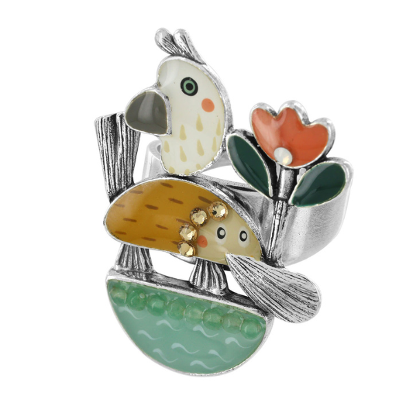 Image of quirky ring featuring hand painted platypus, flowers and bird on silver metal finish.