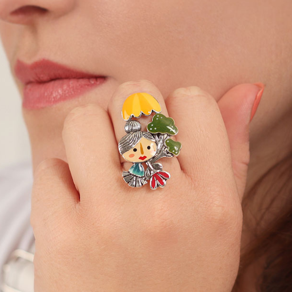 Image of model wearing colourful Josi Brocoli character ring on silver finish.