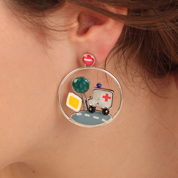 Image of model wearing colourful hand painted earrings with ambulance and car on road as features inside hoop.