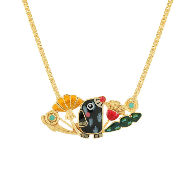 Image of pretty mole feature necklace with foliage surrounding feature.