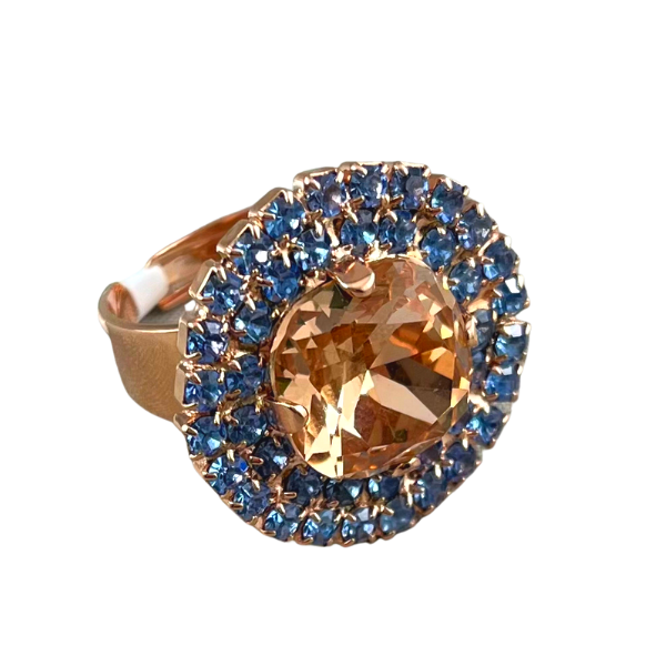 Image of large round dress ring on 18 carat rose gold using large champagne crystal centre edged with double layered blue seed crystals.