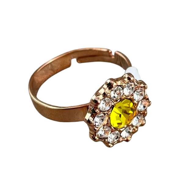 Image of adjustable flower shaped ring with yellow crystal centre surrounded by diamond seed crystals set on 18ct rose gold plated metal.