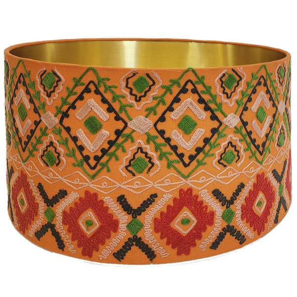 Image of cotton lampshade with tribal diamonds pattern in orange, green and red embroidery.