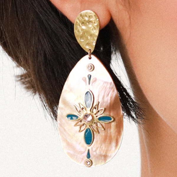 Image of model wearing extra large teardrop brown lip dangle earrings encrusted with pink swarovski crystals.