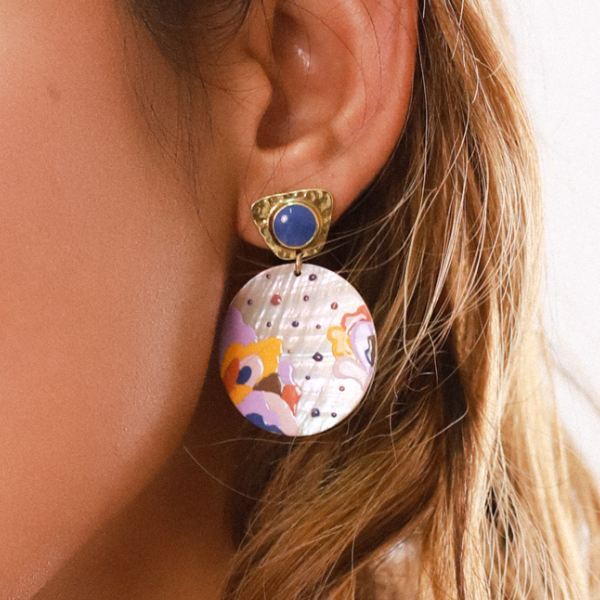 Image of creole style drop earrings with hand painted coloured patterns onto a pink mop disc