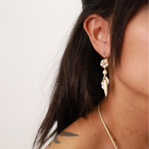 Image of ivory coloured, dangle earrings with a star top.