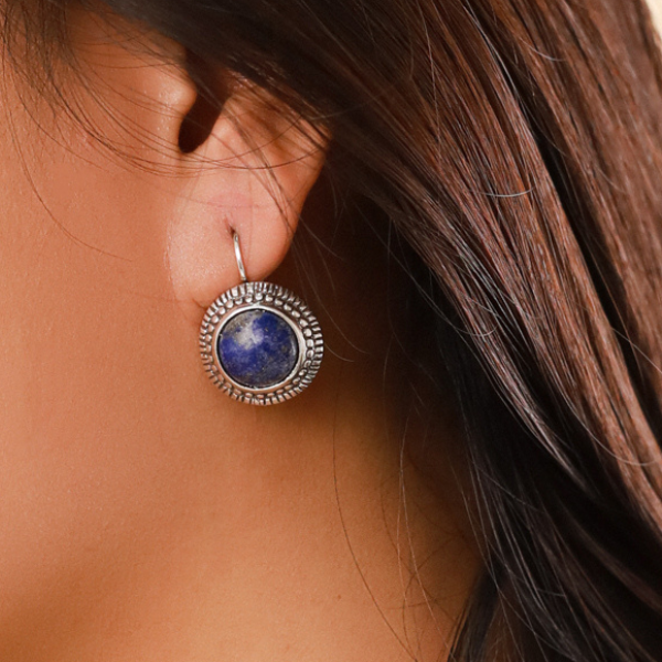 Image of model wearing pretty round drop earrings made with lapius luzil on silver french Hook.