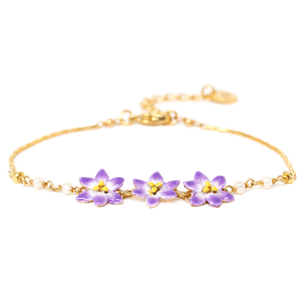 Image of dainty gold metal bracelet with 3 lilac flowers centrepiece.