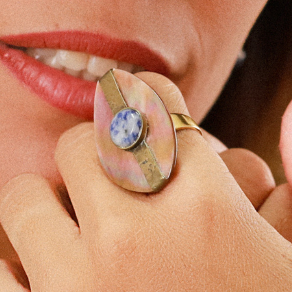 Image of large oval brown lip ring with sodalite centrepiece.