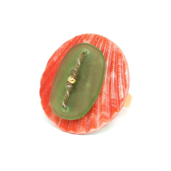 Image of large round ring with orange disc and green oval stone on top with gold plated finish.