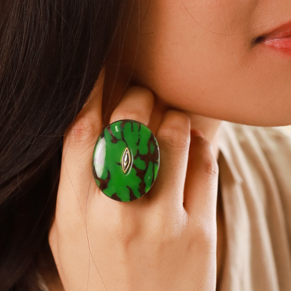 Image of model wearing chunky ring in termite mound malachite green colour and theme.