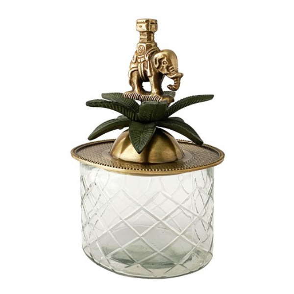 Image of a classical trinket box that combines cut glass with brass.  Stunning brass lid with elephant and green coloured brass palm leaves sits atop an elegant cut glass container.  