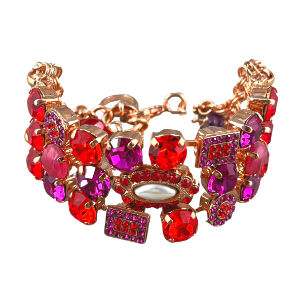 Image of wide, crystal embellished bracelet set with red, pink, fuchsia and mauve crystals on 18ct rose gold plated metal.