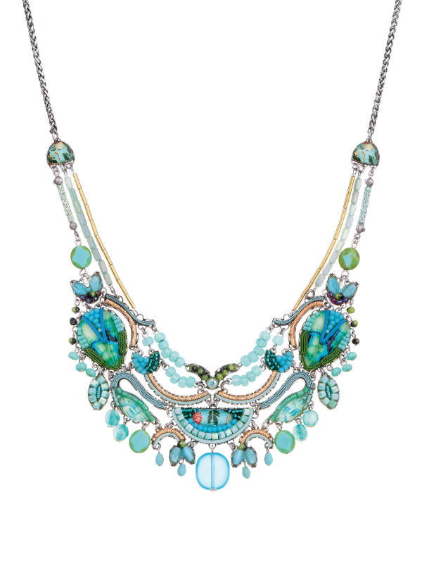 Image of elegant necklace made skillfully by hand using coloured textiles, glass and metals in green and blue tones.