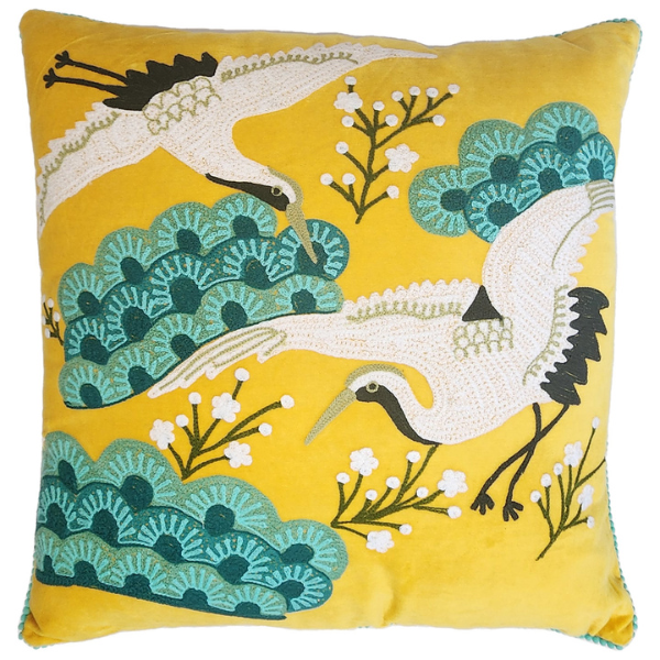 Image of yellow velvet cushion with Japanese crane bird embroidery.