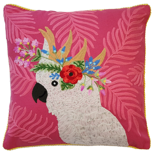 Image of pink cotton cushion with white cockatoo and native flowers embroidery.