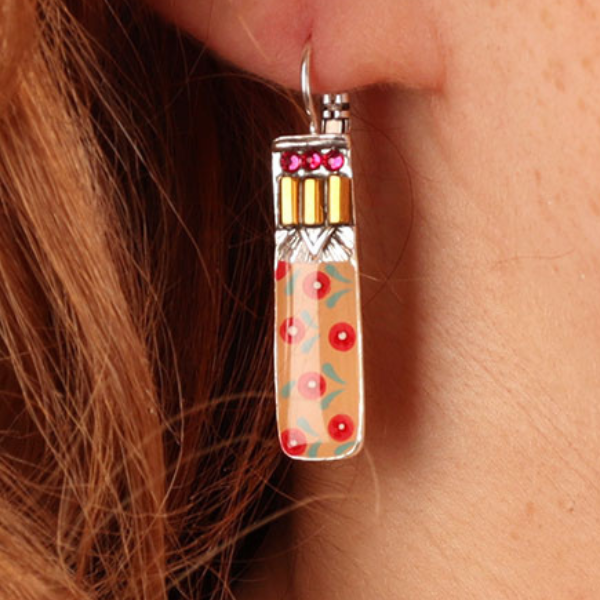 Image of model wearing cute ethnic style drop earrings hand painted in yellow shades with coloured precious stones and beads on silver french hook.