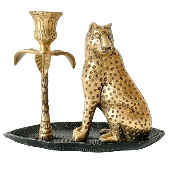 Image of statuesque brass leopard candle holder formed from brass sitting on a black leaf.  How impressive would this be sitting in your dining/family room?