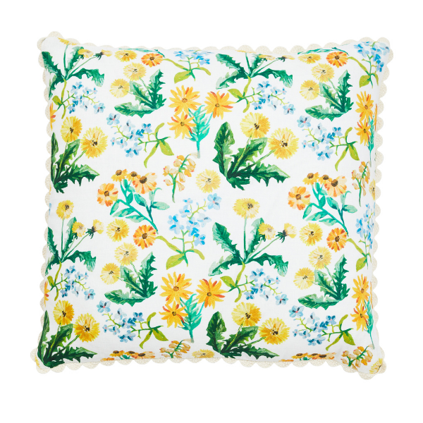 Image of cushion with yellow dandelion floral pattern on white linen with scallop piping.