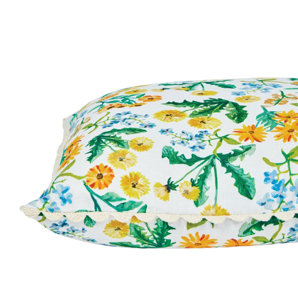 Image of cushion with yellow dandelion floral pattern on white linen with scallop piping.