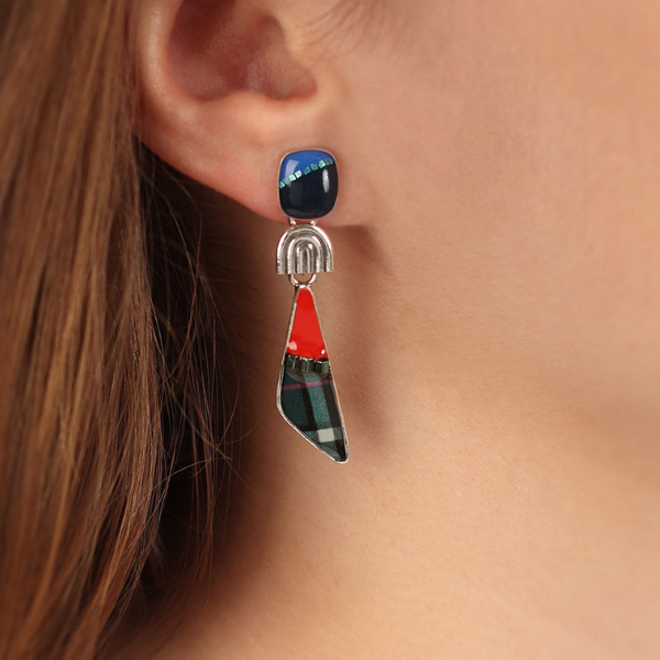 Image of model wearing multi coloured dangle earrings with silver finish.
