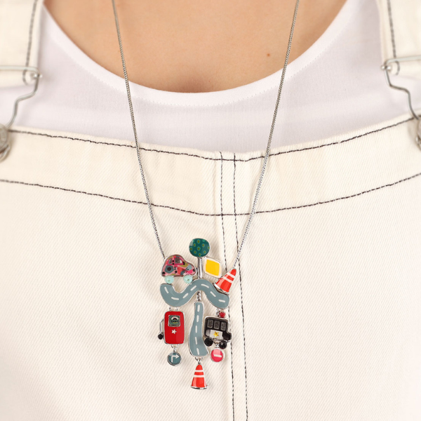 Image of model wearing ffbeat necklace of roads and emergency vehicles hand painted patterns and stones.