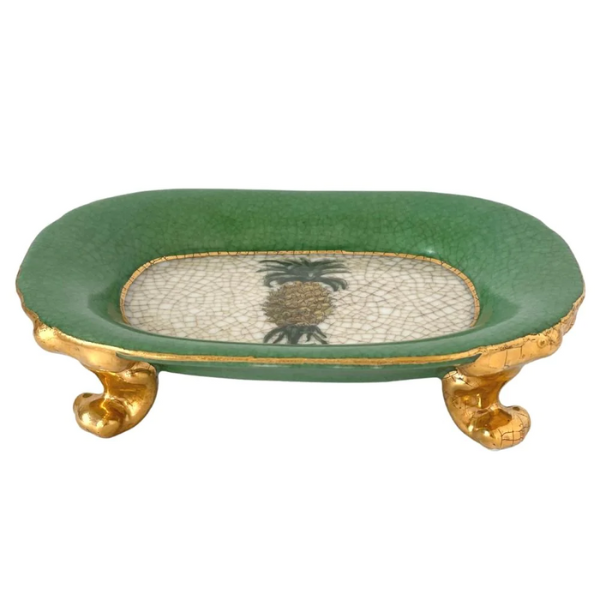 Image of vintage style artwork dish from CAM featuring a pineapple on the dish an antique finish gold painted feet and green edges.