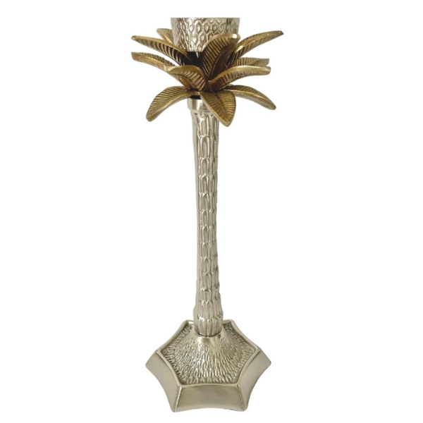 Image of brass palm tree candle holder on silver finish and gold leaves.