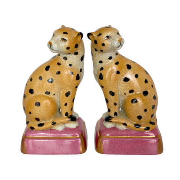 Image of leopard porcelain bookends on squat pink plinth.