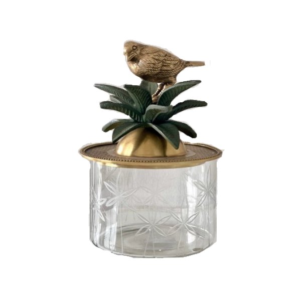 Image of a classical trinket box that combines cut glass with brass.  Stunning brass lid with bird and verde coloured brass palm leaves sits atop a elegant cut glass container.  