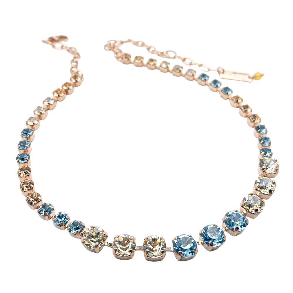 Necklace with blue and clear gemstones on a white background