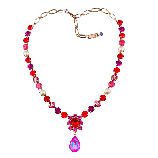 Image of pink, purple, red Swarovski crystal necklace with pink and red flower centrepiece attached with an iridized pink crystal teardrop dangle. Set in 18ct Rose gold plated metal.