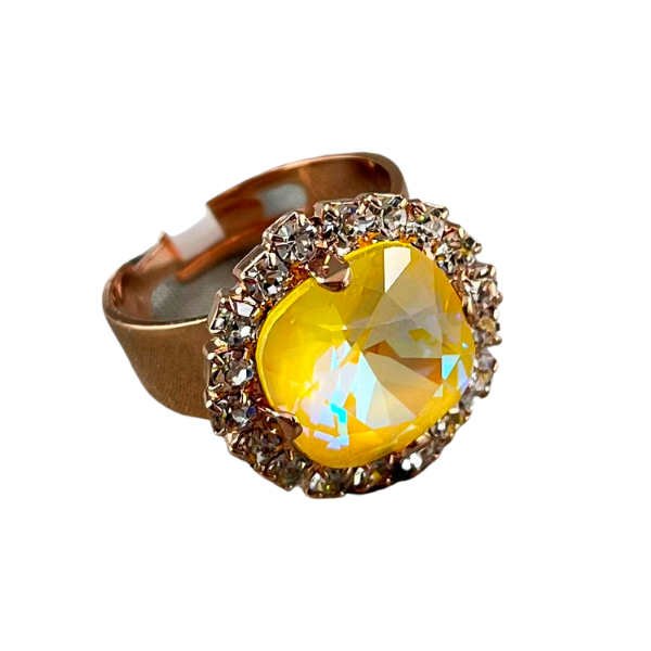 Image of round dress ring on 18 carat rose gold. Large iridized yellow crystal centre edged with a layer of seed diamond crystals.