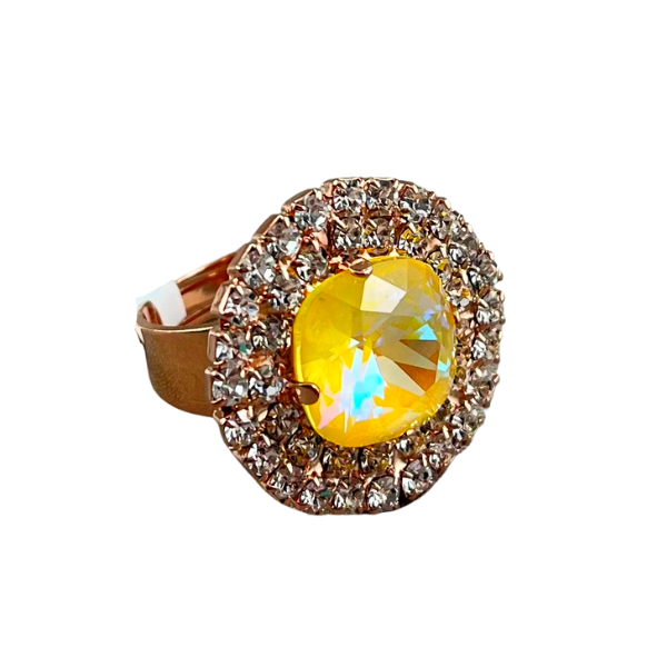 Image of large round dress ring on 18 carat rose gold. Large iridized yellow crystal centre edged with double layered tiny seed diamond crystals.