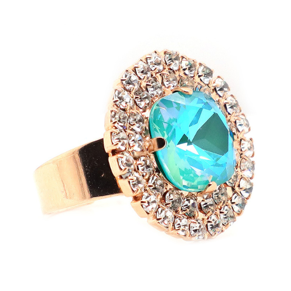 Image of large round dress ring on 18 carat rose gold. Large aqua crystal centre edged with double layered tiny seed diamond crystals.