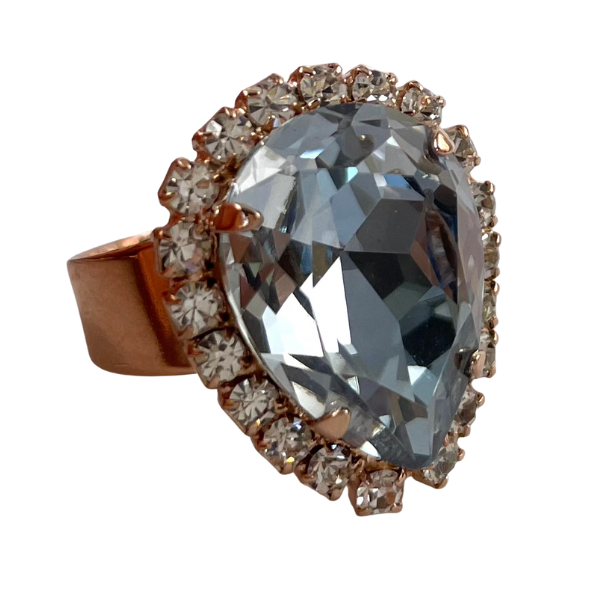 Image of dress ring featuring large diamond teardrop Swarovski crystal trimmed with diamond seed crystals. 18ct rose gold plated band.