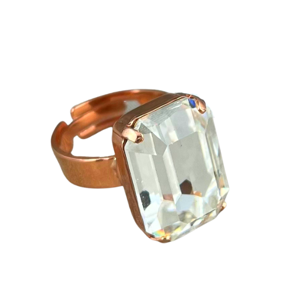 Image of dress ring featuring a large, rectangular diamond crystal on an adjustable 18ct rose gold plated band.