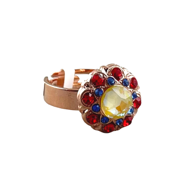 Image of colourful crystal dress ring set with red blue and yellow crystals on an adjustable rose gold plated band.