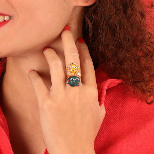 Image of model wearing gold metal ring with sun and cloud happy faces as centre piece.
