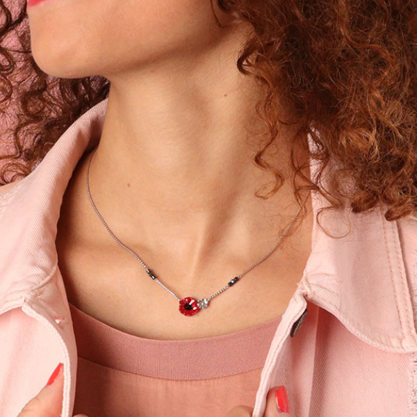 Image of model wearing dainty necklace with hand painted poppy and silver metal flower centrepiece.
