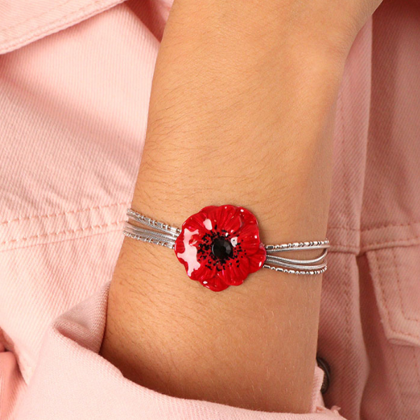 Image of model wearing multi chain bracelet with hand painted poppy centrepiece.