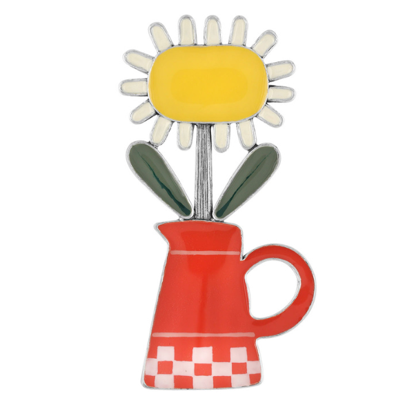 Image of bright pretty brooch with yellow and white sunflower sitting in a red watering can all on silver metal pin finish.