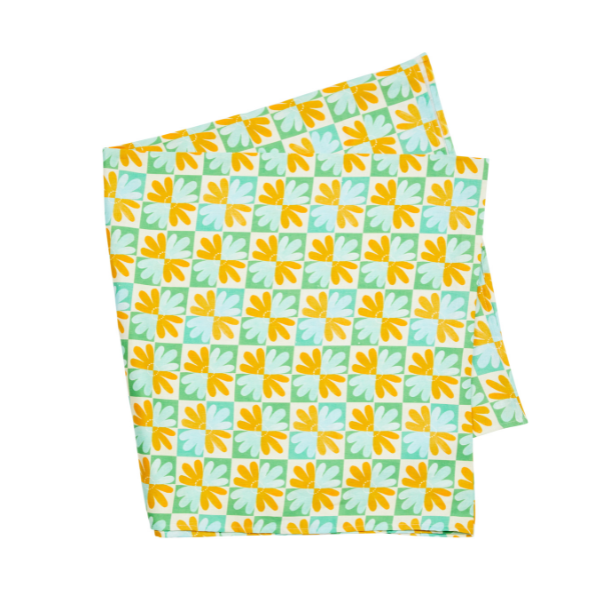 Image of linen tablecloth screen printed with a green and yellow contemporary pattern.