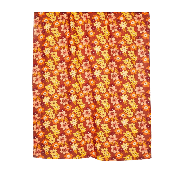 Image of linen tablecloth with yellow, peach and ochre flowers on a rust brown background.