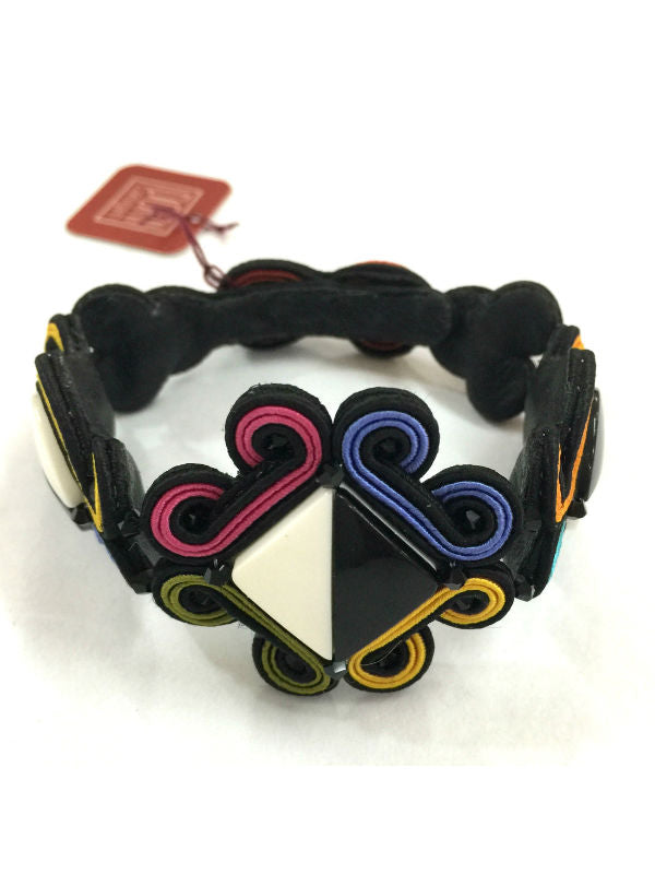 Image of striking bracelet with man-made geometric shape elements, Swarovski crystal beads and textile cords.